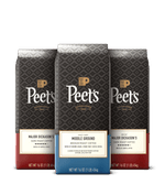 Three Peet's coffee bags with different roast levels on a black background